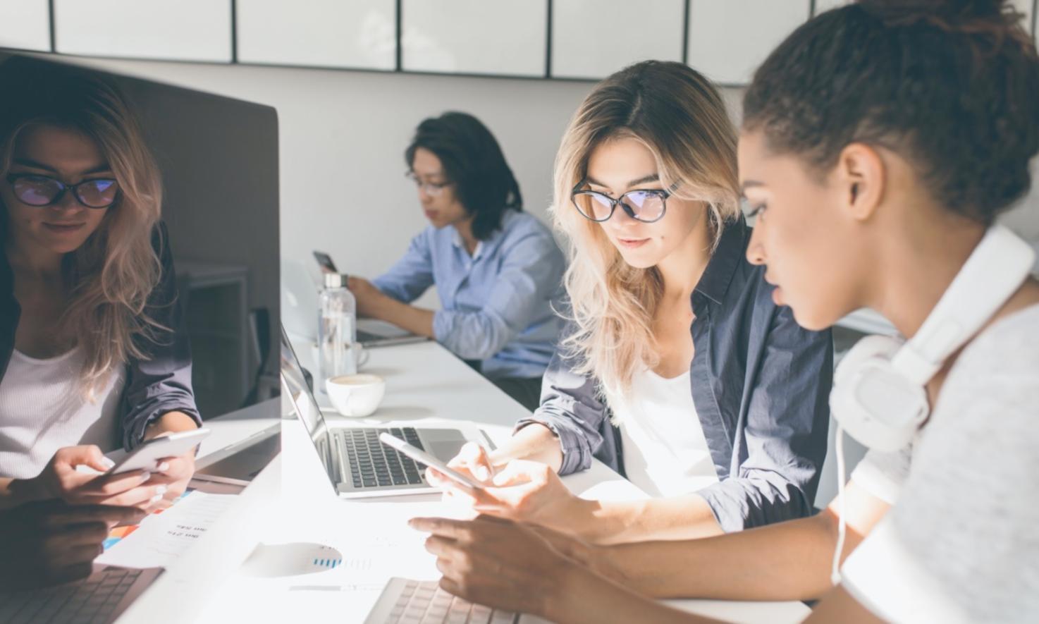 Person reviewing financial documents and charts at desk